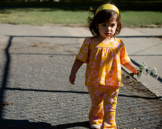 girl in two piece mustard and pink retro floral outfit