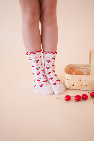 White socks with red cherries and pink hearts 
